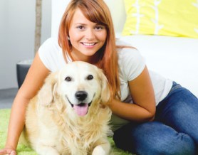 woman sitting on floor with dog