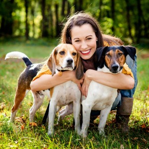 beautiful woman and his dogs posing outside